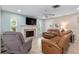 Comfortable living room with fireplace, TV, and plush seating at 4415 Charing Cross Rd, Sarasota, FL 34241
