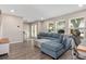 Spacious living room showcasing hardwood flooring, a comfortable sofa, and natural light at 4415 Charing Cross Rd, Sarasota, FL 34241