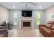 Comfortable living room with fireplace, TV, and plush seating at 4415 Charing Cross Rd, Sarasota, FL 34241
