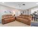 Spacious living area with comfortable seating, modern decor, and adjacent kitchen access at 4415 Charing Cross Rd, Sarasota, FL 34241