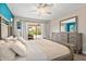Beautiful main bedroom with a view of the pool, neutral tones and a ceiling fan at 4415 Charing Cross Rd, Sarasota, FL 34241