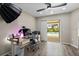 Home office with hardwood flooring, modern desk setup, and sliding doors to an outdoor pool at 4415 Charing Cross Rd, Sarasota, FL 34241
