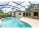 Backyard swimming pool featuring clear water, a screened enclosure, steps, and an extended deck for lounging at 4415 Charing Cross Rd, Sarasota, FL 34241