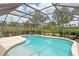 Enclosed in-ground pool featuring a tile trim, sunny deck, and a surrounding screen at 4415 Charing Cross Rd, Sarasota, FL 34241