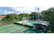 An overhead view of tennis courts and a swimming pool creates a diverse recreational community at 4505 45Th W Ave # 101B, Bradenton, FL 34210