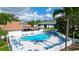 Community pool with lounge chairs, umbrellas, and spa, nestled amidst well-maintained buildings and manicured landscaping at 4505 45Th W Ave # 101B, Bradenton, FL 34210
