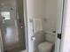 Clean and functional bathroom with a glass-enclosed shower and standard toilet at 4505 45Th W Ave # 101B, Bradenton, FL 34210