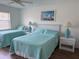 Bright bedroom with two twin beds, coastal decor, and matching nightstands at 4505 45Th W Ave # 101B, Bradenton, FL 34210