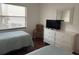 Well-lit bedroom with two twin beds, a dresser, and ample natural light from a window at 4505 45Th W Ave # 101B, Bradenton, FL 34210