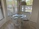 Charming breakfast nook featuring natural light and a glass-top table with four rattan chairs at 4505 45Th W Ave # 101B, Bradenton, FL 34210