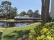 Beautiful community pool area overlooking the serene pond, perfect for relaxation at 4505 45Th W Ave # 101B, Bradenton, FL 34210