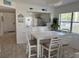 Dining area featuring a white table set, bright natural light, and stylish decor at 4505 45Th W Ave # 101B, Bradenton, FL 34210