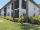 Charming condo exterior with screened lanais, complemented by lush landscaping at 4505 45Th W Ave # 101B, Bradenton, FL 34210