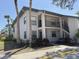 Exterior of two-story condo building with neutral color, lush green landscape, and a parking spot at 4505 45Th W Ave # 101B, Bradenton, FL 34210