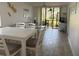 Bright, open-concept living room with dining area and screened lanai access at 4505 45Th W Ave # 101B, Bradenton, FL 34210