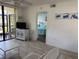 Bright living room offering screened lanai access and a view into the main bedroom at 4505 45Th W Ave # 101B, Bradenton, FL 34210