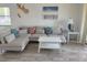 Bright living room featuring a large sectional sofa and a sliding door to the balcony at 4505 45Th W Ave # 101B, Bradenton, FL 34210