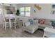 Open-concept living room with dining area, modern furniture, and bright natural light at 4505 45Th W Ave # 101B, Bradenton, FL 34210