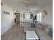 Bright living room with a cozy sectional sofa, an airy ceiling fan, and light-colored wood-look tile flooring at 4505 45Th W Ave # 101B, Bradenton, FL 34210