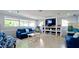 Comfortable resident lounge area with plush seating, bookshelves, and large windows for natural light at 4505 45Th W Ave # 101B, Bradenton, FL 34210