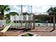 Charming outdoor playground with slide, swing set and tennis court offering recreation for residents of all ages at 4505 45Th W Ave # 101B, Bradenton, FL 34210