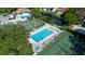 Aerial view of an inviting pool, hot tub, and nearby tennis court within a community setting at 4505 45Th W Ave # 101B, Bradenton, FL 34210