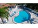 Aerial view of a unique pool design with surrounding patio and lounge area at 4505 45Th W Ave # 101B, Bradenton, FL 34210