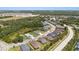 An aerial view of a charming neighborhood near tranquil ponds and a mix of lush trees at 4515 Roycroft Ter, Parrish, FL 34219