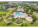 Beautiful community pool area with lush landscaping, playgrounds, and a clubhouse, perfect for Gathering fun and relaxation at 4515 Roycroft Ter, Parrish, FL 34219