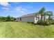 Spacious backyard featuring a lush lawn, mature landscaping, and a serene outdoor setting at 4515 Roycroft Ter, Parrish, FL 34219