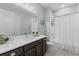 Bathroom featuring a vanity with white countertop, wood cabinets, and a shower with curtain at 4515 Roycroft Ter, Parrish, FL 34219