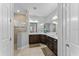 Bathroom features dark wood cabinets, dual sinks, and tiled walk-in shower at 4515 Roycroft Ter, Parrish, FL 34219