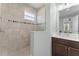 Modern bathroom features neutral tile, glass shower, and vanity with a clean, contemporary aesthetic at 4515 Roycroft Ter, Parrish, FL 34219