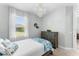 Cozy bedroom with lots of natural light, features a decorative light fixture and dresser at 4515 Roycroft Ter, Parrish, FL 34219