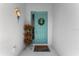 Charming entryway featuring a blue door, decorative wreath, and potted plants at 4515 Roycroft Ter, Parrish, FL 34219