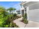Inviting walkway with lush garden beds leading to the home's entrance and garage at 4515 Roycroft Ter, Parrish, FL 34219