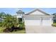 Charming single-story home with a two-car garage, well-manicured lawn, and lush landscaping at 4515 Roycroft Ter, Parrish, FL 34219