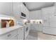 Modern kitchen featuring white cabinetry, granite countertops, and stainless steel appliances at 4515 Roycroft Ter, Parrish, FL 34219