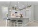 Modern kitchen with a large island, pendant lighting, and stainless steel appliances at 4515 Roycroft Ter, Parrish, FL 34219