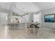 Open kitchen and dining area featuring tile floors, stylish lighting and modern appliances at 4515 Roycroft Ter, Parrish, FL 34219
