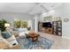Bright living room with tile floors, modern furnishings, and sliding glass doors to a screened outdoor pool at 4515 Roycroft Ter, Parrish, FL 34219