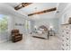 Spacious main bedroom boasts a beamed ceiling, a comfy chair, and a dresser for ample storage at 4515 Roycroft Ter, Parrish, FL 34219