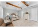 Elegant main bedroom with beamed ceilings, chandelier, and a comfortable chair at 4515 Roycroft Ter, Parrish, FL 34219
