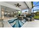 Covered patio showcasing a fire pit, comfortable seating, and seamless indoor-outdoor living at 4515 Roycroft Ter, Parrish, FL 34219