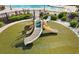 Community playground equipment on astroturf with slides, perfect for children to play and socialize at 4515 Roycroft Ter, Parrish, FL 34219