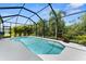 Screened pool surrounded by lush landscaping, offering a private and refreshing outdoor oasis at 4515 Roycroft Ter, Parrish, FL 34219