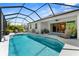 Backyard with a screened in pool, lush landscaping, lounge chairs, and seamless indoor-outdoor living at 4515 Roycroft Ter, Parrish, FL 34219