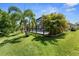 Gorgeous backyard with an enclosed pool surrounded by tropical landscaping for privacy and shade at 4515 Roycroft Ter, Parrish, FL 34219