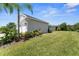 Side exterior view showcasing the well-maintained lawn, landscaping, and architectural details at 4515 Roycroft Ter, Parrish, FL 34219