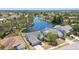 Beautiful aerial view of a home on the water with a lush green landscape and blue lake at 4604 9Th E Ave, Bradenton, FL 34208